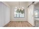 Dining area with sliding barn door and modern chandelier at 1326 W Seascape Dr, Gilbert, AZ 85233