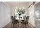 Modern dining room featuring a glass-top table and four chairs at 1326 W Seascape Dr, Gilbert, AZ 85233