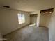 Well-lit bedroom featuring a closet and window at 14017 N 40Th Ave, Phoenix, AZ 85053