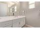 Bathroom with a double vanity and large mirror at 15130 W Linden St, Goodyear, AZ 85338