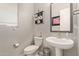 Small bathroom with pedestal sink and toilet at 15130 W Linden St, Goodyear, AZ 85338