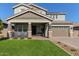 Two-story house with a green lawn, two-car garage, and front porch at 15130 W Linden St, Goodyear, AZ 85338