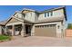 Two-story house with a brick driveway and a two-car garage at 15130 W Linden St, Goodyear, AZ 85338