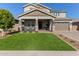 Two-story house with a green lawn, two-car garage, and front porch at 15130 W Linden St, Goodyear, AZ 85338