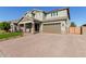 Two-story house with a brick driveway and a two-car garage at 15130 W Linden St, Goodyear, AZ 85338