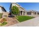 Two story house with a landscaped yard and a tree at 15130 W Linden St, Goodyear, AZ 85338