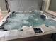 Modern hot tub with multiple jets and a cover at 15130 W Linden St, Goodyear, AZ 85338