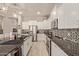 Modern kitchen with white cabinets, granite counters, and stainless steel appliances at 15130 W Linden St, Goodyear, AZ 85338