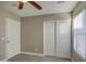 Well-lit bedroom featuring a ceiling fan and closet at 1633 S 171St Dr, Goodyear, AZ 85338