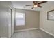 Bright bedroom with ceiling fan and sliding door closet at 1633 S 171St Dr, Goodyear, AZ 85338