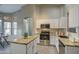 Modern kitchen featuring granite island and white cabinetry at 1633 S 171St Dr, Goodyear, AZ 85338