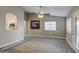 Living room with tile floors, large windows and a view to the kitchen at 1633 S 171St Dr, Goodyear, AZ 85338