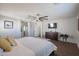 Main bedroom with wood floors, a large bed, and a TV at 17338 W Woodrow Ln, Surprise, AZ 85388