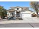 Two-story house with a three-car garage and desert landscaping at 17338 W Woodrow Ln, Surprise, AZ 85388