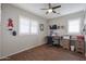 Home office with wood floors, desk, and large windows with plantation shutters at 17338 W Woodrow Ln, Surprise, AZ 85388