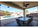 Relaxing patio with pool view, seating area, and grill at 17338 W Woodrow Ln, Surprise, AZ 85388