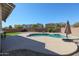 Relaxing kidney-shaped pool surrounded by desert landscaping at 17338 W Woodrow Ln, Surprise, AZ 85388