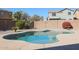 Sparkling kidney-shaped pool with ample patio space at 17338 W Woodrow Ln, Surprise, AZ 85388