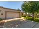 View of the front of the house, showing the garage and lawn at 18881 N 91St Dr, Peoria, AZ 85382