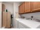 Laundry room with washer, dryer, and storage cabinets at 18881 N 91St Dr, Peoria, AZ 85382