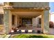 Covered patio with seating area and potted plants at 18881 N 91St Dr, Peoria, AZ 85382