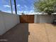 Private backyard with wooden gate and grassy area at 1922 N 25Th St, Phoenix, AZ 85008