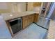 Granite kitchen island with wine cooler and ample storage at 19624 N 16Th Dr, Phoenix, AZ 85027