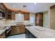 Granite kitchen island with wine cooler and access to backyard at 19624 N 16Th Dr, Phoenix, AZ 85027