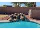 Close-up of a charming waterfall feature in the pool at 19624 N 16Th Dr, Phoenix, AZ 85027