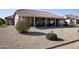 Landscaped backyard with a large covered patio at 20825 N Limousine Dr, Sun City West, AZ 85375