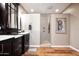 Spa-like bathroom with walk-in shower and dark cabinets at 20825 N Limousine Dr, Sun City West, AZ 85375