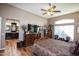 Bright bedroom with ensuite bathroom and large TV at 20825 N Limousine Dr, Sun City West, AZ 85375