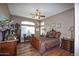 Elegant bedroom featuring a king-size bed and antique furniture at 20825 N Limousine Dr, Sun City West, AZ 85375