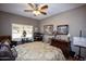 Spacious bedroom featuring a ceiling fan and large window at 20825 N Limousine Dr, Sun City West, AZ 85375