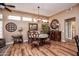 Elegant dining room with wood flooring and a round table at 20825 N Limousine Dr, Sun City West, AZ 85375