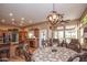 Open concept dining area with kitchen view and wood floors at 20825 N Limousine Dr, Sun City West, AZ 85375