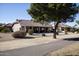 Home's exterior back view with covered patio and landscaping at 20825 N Limousine Dr, Sun City West, AZ 85375