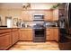 Modern kitchen with stainless steel appliances and wood cabinets at 20825 N Limousine Dr, Sun City West, AZ 85375