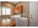 Bright laundry room with cabinets and utility sink at 20825 N Limousine Dr, Sun City West, AZ 85375