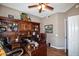 Bright home office with ceiling fan and wood desk at 20825 N Limousine Dr, Sun City West, AZ 85375