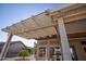 White wooden pergola offering shade and outdoor living space at 20825 N Limousine Dr, Sun City West, AZ 85375