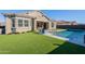 Spacious backyard with a refreshing pool and lush green grass at 21097 E Sparrow Dr, Queen Creek, AZ 85142