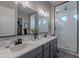 Elegant bathroom with double vanity, large shower, and modern fixtures at 21097 E Sparrow Dr, Queen Creek, AZ 85142