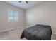 Bright bedroom featuring carpeted floors and a ceiling fan at 21097 E Sparrow Dr, Queen Creek, AZ 85142