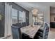 Elegant dining area with marble table and view to backyard at 21097 E Sparrow Dr, Queen Creek, AZ 85142