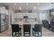 Modern kitchen with white cabinets, large island, and stainless steel appliances at 21097 E Sparrow Dr, Queen Creek, AZ 85142