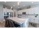 Modern kitchen with white cabinets, large island, and stainless steel appliances at 21097 E Sparrow Dr, Queen Creek, AZ 85142