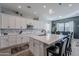 Modern kitchen with white cabinets, large island, and stainless steel appliances at 21097 E Sparrow Dr, Queen Creek, AZ 85142