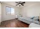 Well-lit bedroom with hardwood floors, a ceiling fan and dresser at 2128 E Leo Pl, Chandler, AZ 85249