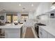 Modern white kitchen with center island, stainless steel appliances, and gold accents at 2128 E Leo Pl, Chandler, AZ 85249